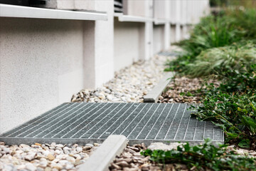 Drain Cover and French Drain along Facade Building Outside. Floor Drainage Grate Covers, Uderground Sewer Water Discharge Systems. 