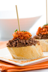 Spanish tapas food. Black pudding pintxo with sautÃ©ed vegetables...