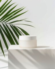 a white container with a green plant in the background
