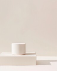 a white cup sitting on top of a white box