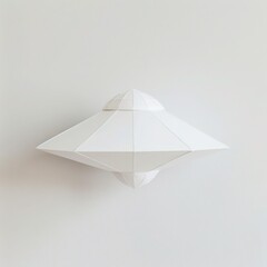 A simple paper UFO, ready for flight, isolated on a clean white background
