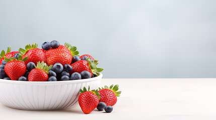 Strawberries in a white deep plate. Fresh berries in a plate, strawberries and blueberries. Berries in a white deep plate. Large pile of fresh berries in a white bowl on a light background, harvest