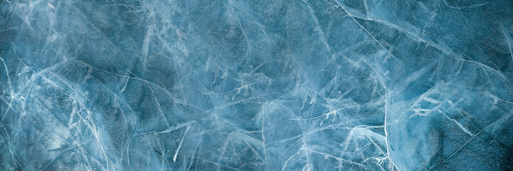 Abstract natural ice texture. Freezy ice surface. Blue backdrop with cracks and scratches on frozen...