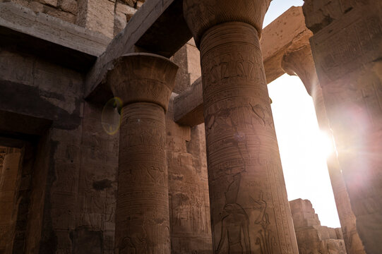 Sunlight on carved columns at Edfu Temple, ancient stonework, historical site