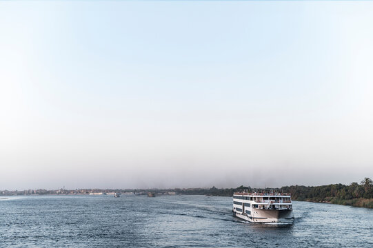 Large cruise boat on Nile River, calm water, scenic journey