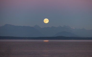 Full moon rising over serene sea