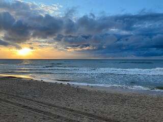 Beautiful sandy beach at cloudy sunset