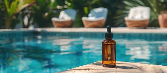 A dropper bottle of face serum or natural oil resting at the pool's edge