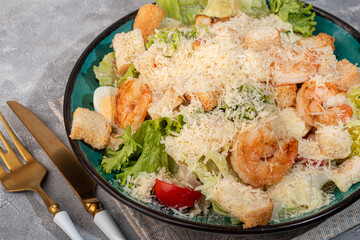 Salad with shrimp and croutons, tomatoes cheese, lettuce sauce. Boiled egg.