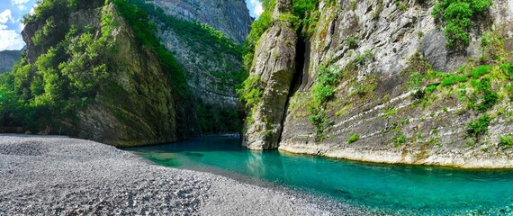 Panoramic aerial image of Shala River canyon and the clear blue waters in northern Albania. 