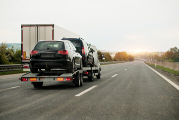Fototapeta premium Towing Truck With A Damaged Vehicle After Car Accident Collision.