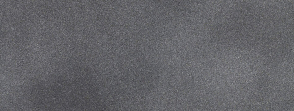 Dark gray matte background of suede fabric, closeup. Velvet texture of black textile, macro.