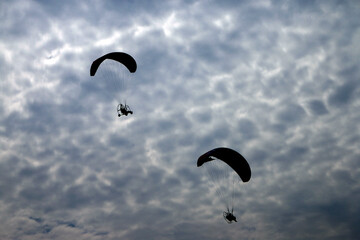 Paramotor vehicle flying over  blue sky, Powered paraglider