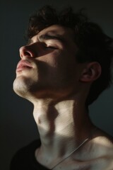 Obraz premium A close-up shot of a person with their eyes shut, possibly in meditation or contemplation