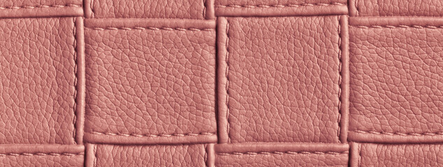 Texture red leather background with square pattern and stitch, macro. Abstract backdrop from maroon textile