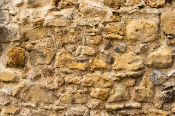 Beige stone wall of ancient city, sand rocks set, texture