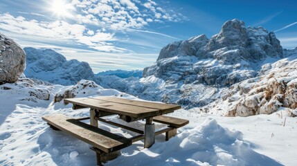 A picnic table set amidst snowy mountains, perfect for winter landscapes and outdoor scenes