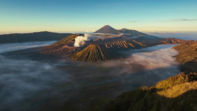 Hyperlapse aerial view flying to mount Bromo active volcano above sea of clouds, Java, Indonesia 
