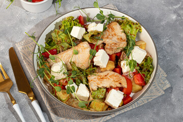 Salad bowl with chicken breast, rice, tomatoes, cucumbers and avocado Boiled egg Copy space