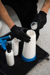 Cleaner is using oxygen cleaner liquid to wash off upholstered furniture. Effective cleaning with...