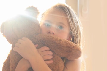 little child 5 years old, blonde girl with toy teddy bear, early diagnosis and intervention,...