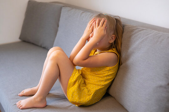 little child 5 years old, blonde girl cries, covering face, early diagnosis and intervention, support for people with autism, protective stance, complains about domestic violence