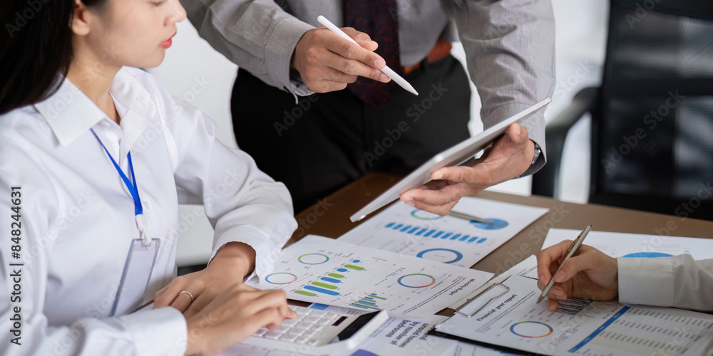 Aufkleber business team discussing analysis and planning in a meeting with charts and graphs on a tablet and d