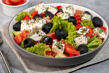 Salad with olives and cucumbers, tomatoes, cheese and sauce. Boiled egg.