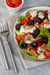 Salad with olives and cucumbers, tomatoes, cheese and sauce. Boiled egg.