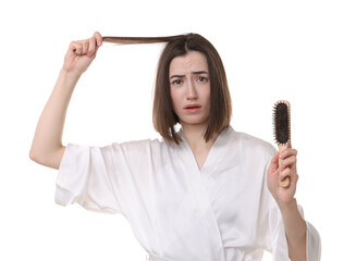 Stressed woman holding brush with lost hair on white background. Alopecia problem