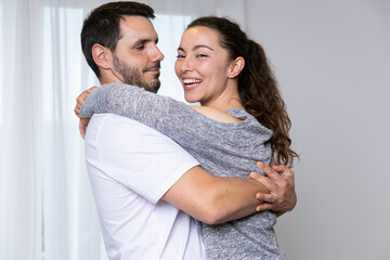 Happy couple packing their stuff to move into their new owned house. They are homeowners, mortgage concept. New home, new life