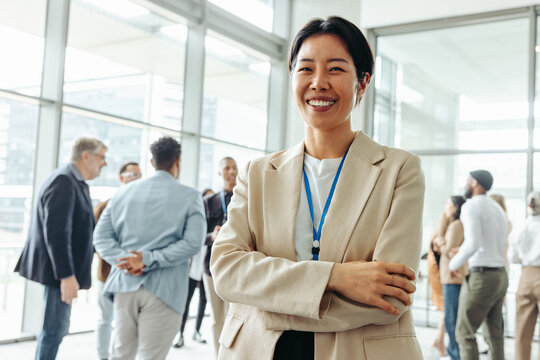 Confident businesswoman at an office event networking with fellow professionals