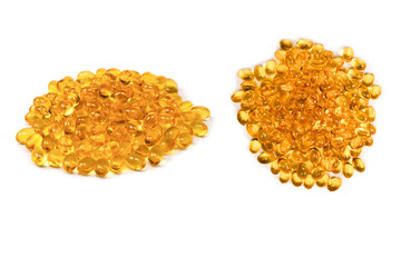 A group of yellow capsules isolated on a white background.