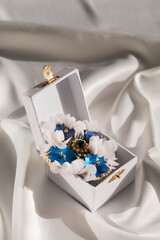Handmade brooch with mother-of-pearl buttons in a small box