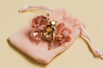 handmade brooch in the shape of a beetle on a plush bag