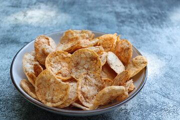 Brown rice chips with spices and salt in bowl