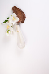Jasmine essential, bark and Jasmine flowers on white background. Copy space. Flat lay