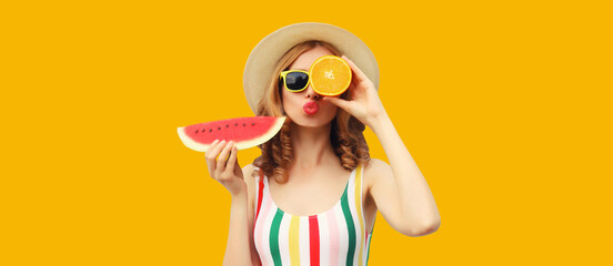 Summer portrait of happy young woman with fresh fruits, slice of watermelon on yellow background
