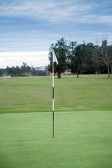 Obraz premium Empty golf course and white flag.