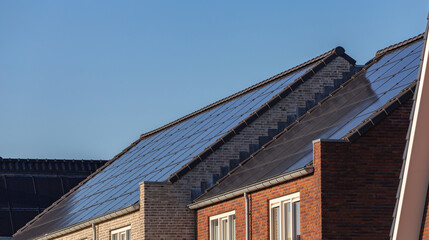 Solar panels on the roofs of houses on a sunny day
