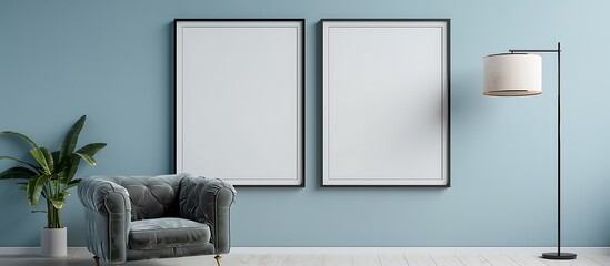 Two square frames on a light blue wall in a living room with a gray velvet armchair and a modern...