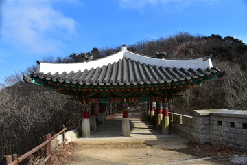 Traditional Korean building Daenammun Gate, a part of the old stone fortification wall running along the mountain ridges in Bukhansan National Park