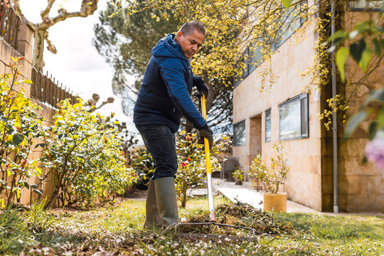 Man tending to garden tasks during vibrant spring day