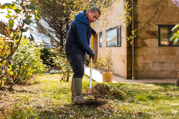 Man tending to garden during springtime cleanup