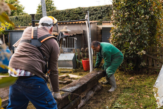 Two men working together in a garden renovation project