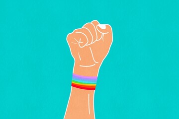 Raised fist with pride band illustration for Pride Day