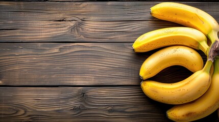Fresh bananas on wooden table ripe tropical fruit with yellow peel sweet flavor top view with space for text