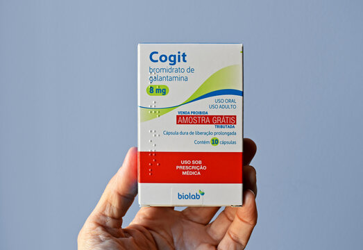 RIO DE JANEIRO, BRAZIL - JUNE 25, 2022: Hand holding a box of galantamine hydrobromide pills 