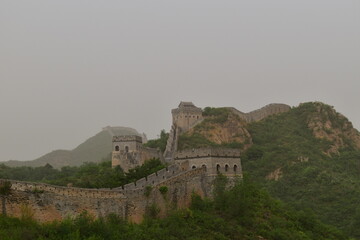 The majestic Great Wall of China in the Chinese mountains north of Beijing in the evening with a...