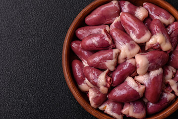 Raw chicken hearts with salt, spices and herbs